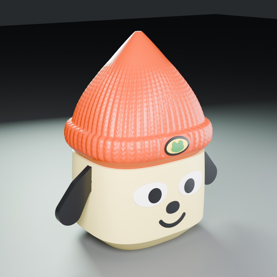 A cream dog head box with floppy ears and an orange knit beanie