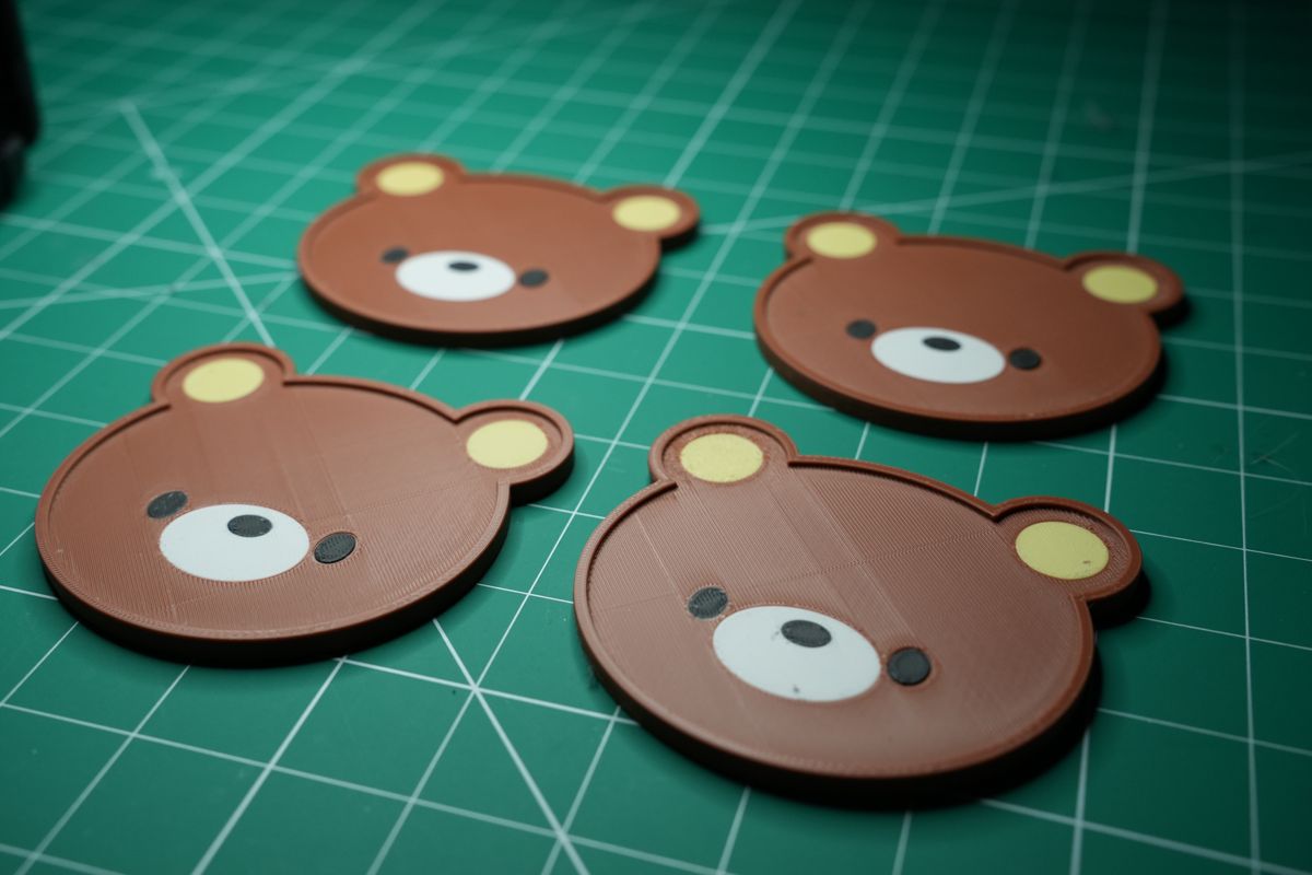 Four bear coasters laid out on the cutting mat