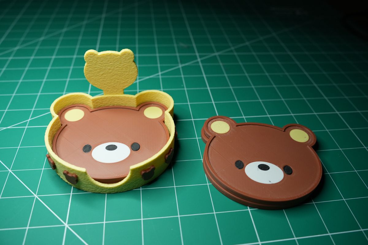 A coaster in the holder and another beside it