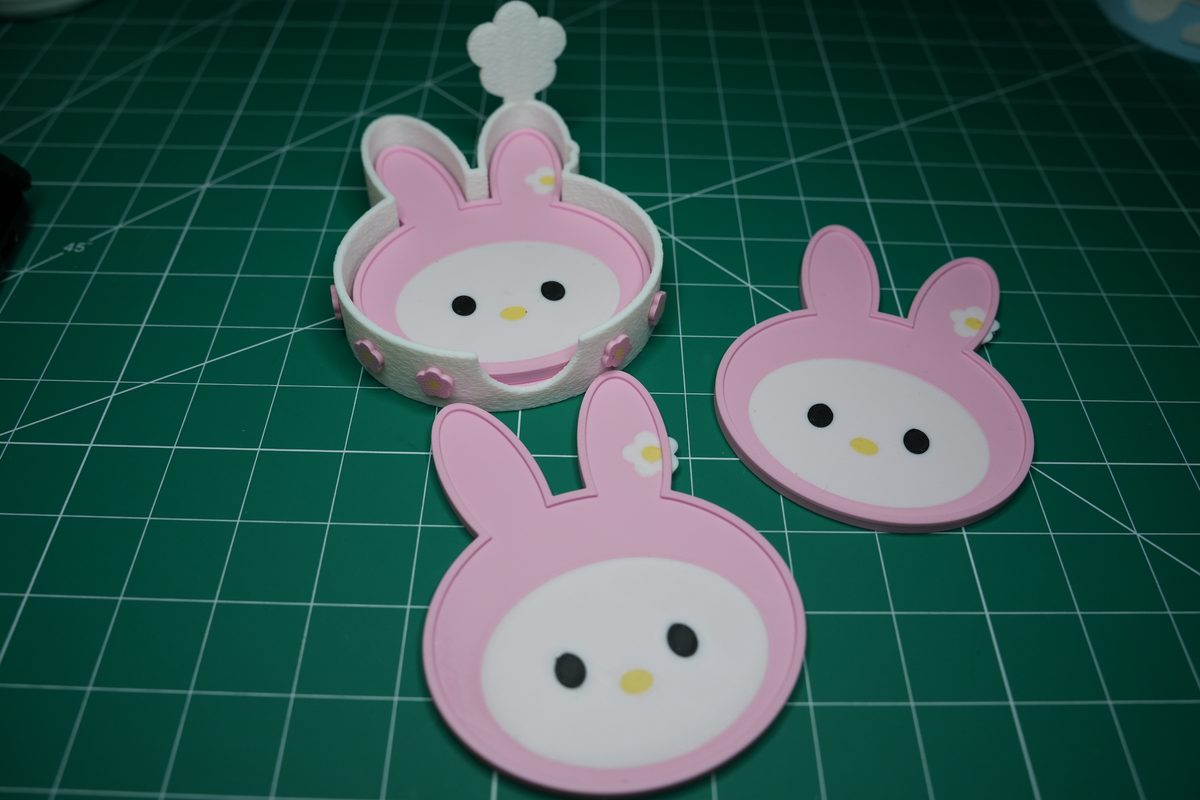 The holder and three bunny coasters on the cutting mat