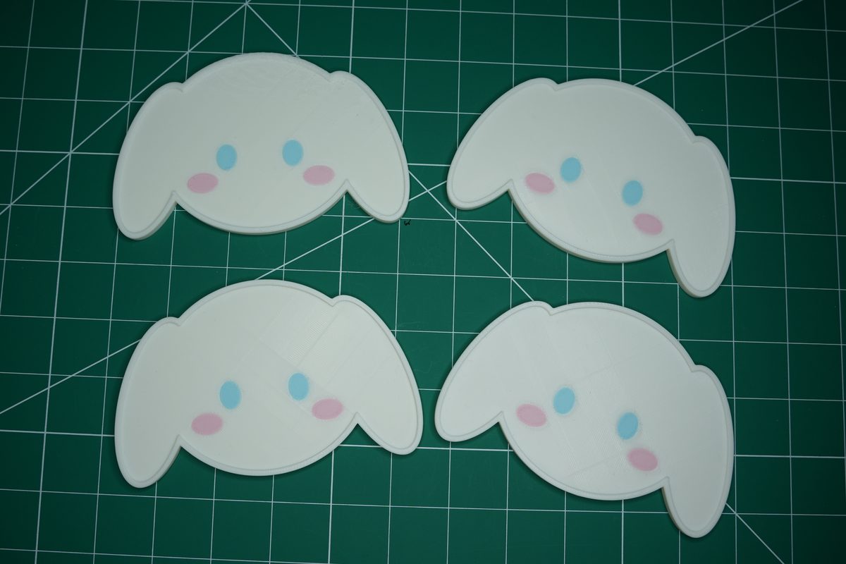 Four puppy coasters on the cutting mat, floppy ears and blue eyes