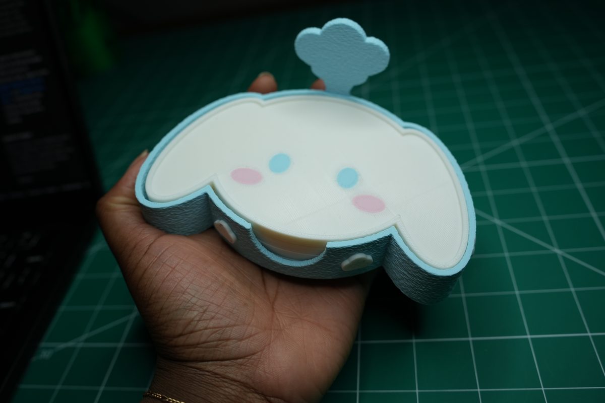 The puppy holder in a hand, showing its size
